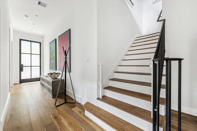 a view of entryway with wooden floor and stairs