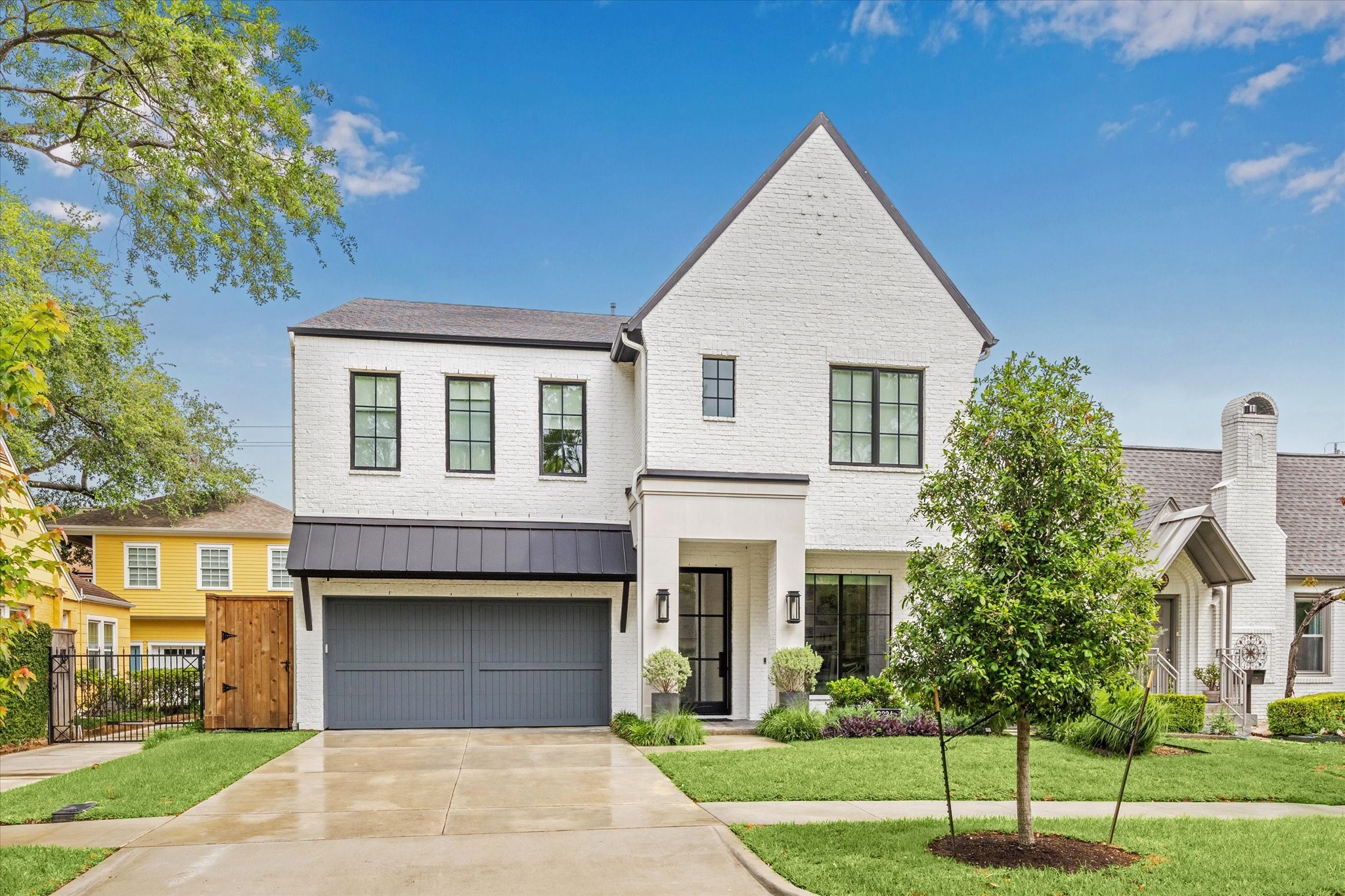 2224 North Boulevard Houston, TX 77098 - Photo 8 of 50 a front view of a house with a yard and trees
