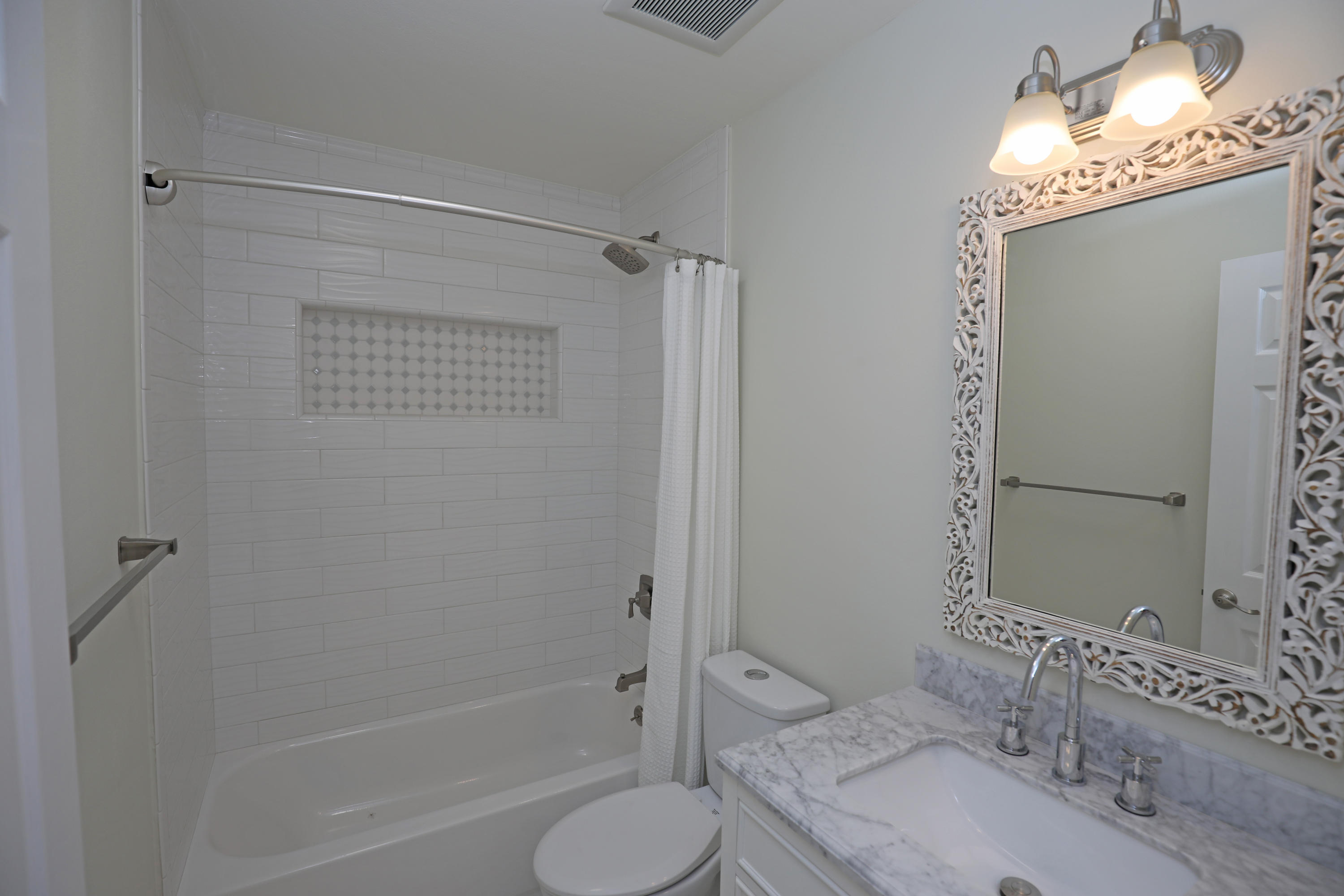7849 Langlo Ranch Road Goleta, CA 93117 - Photo 14 of 17 a bathroom with a granite countertop sink toilet and shower