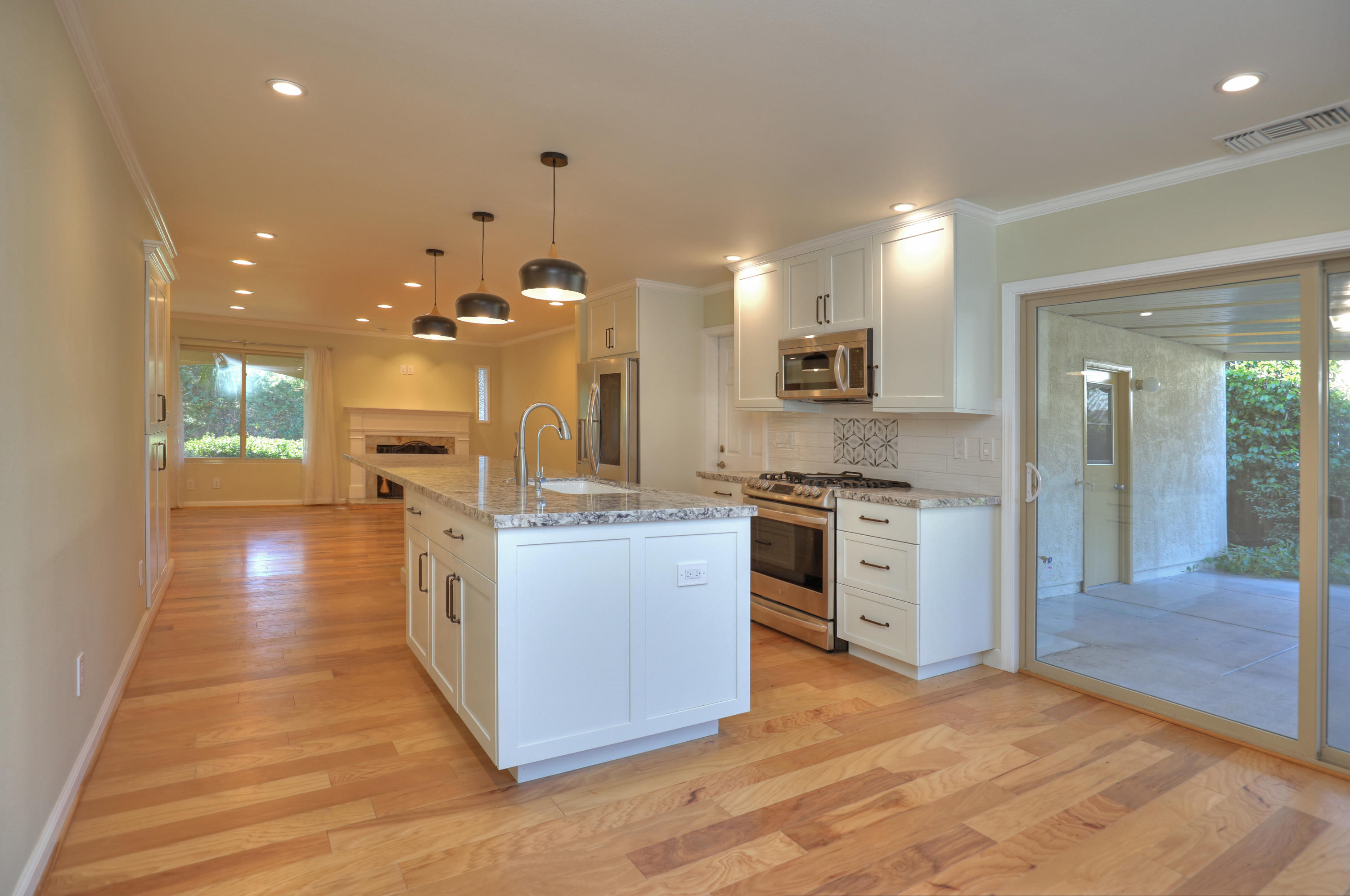 7849 Langlo Ranch Road Goleta, CA 93117 - Photo 4 of 17 a kitchen with stainless steel appliances kitchen island granite countertop a stove top oven a sink and a refrigerator