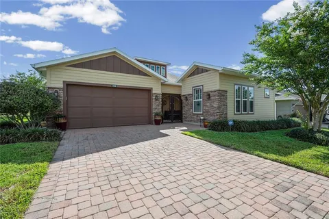 a front view of a house with a yard and a garage