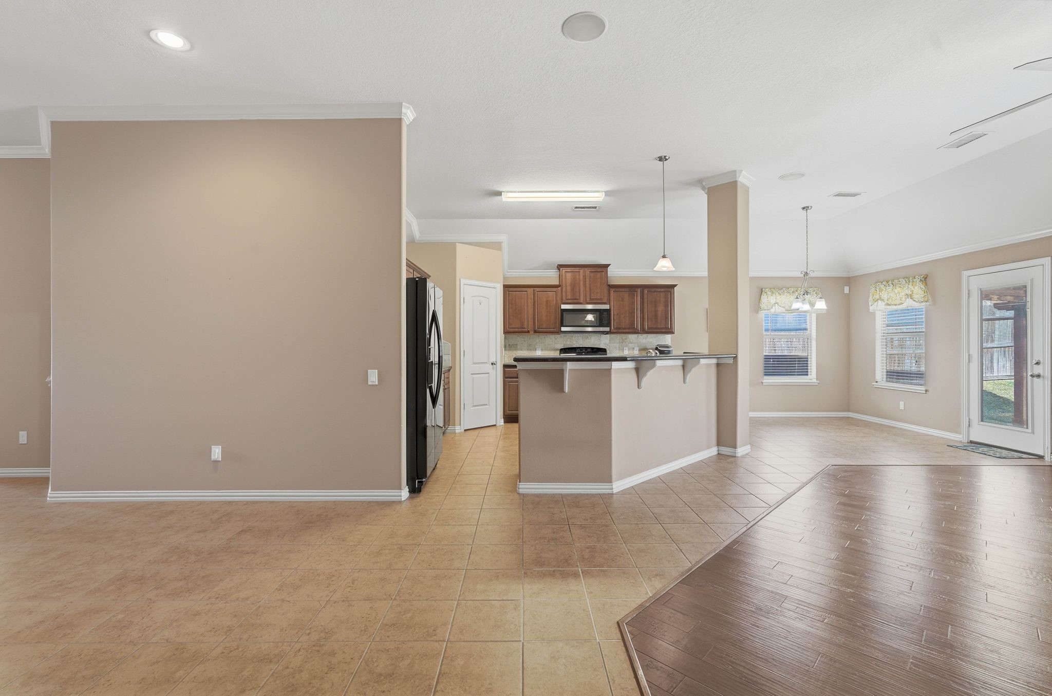 18720 Rosalea Way Montgomery, TX 77356 - Photo 11 of 41 a view of a kitchen with a refrigerator a stove top oven a sink and dishwasher