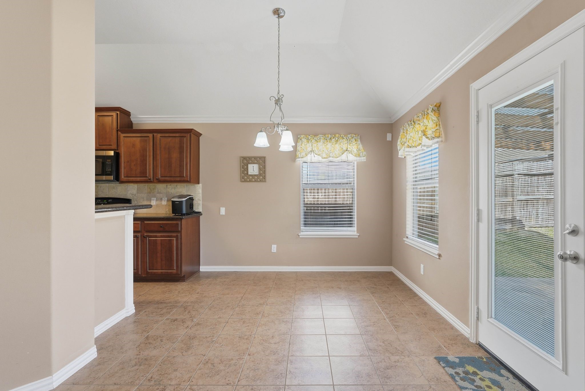 18720 Rosalea Way Montgomery, TX 77356 - Photo 12 of 41 a kitchen with kitchen island granite countertop a stove a sink and a refrigerator