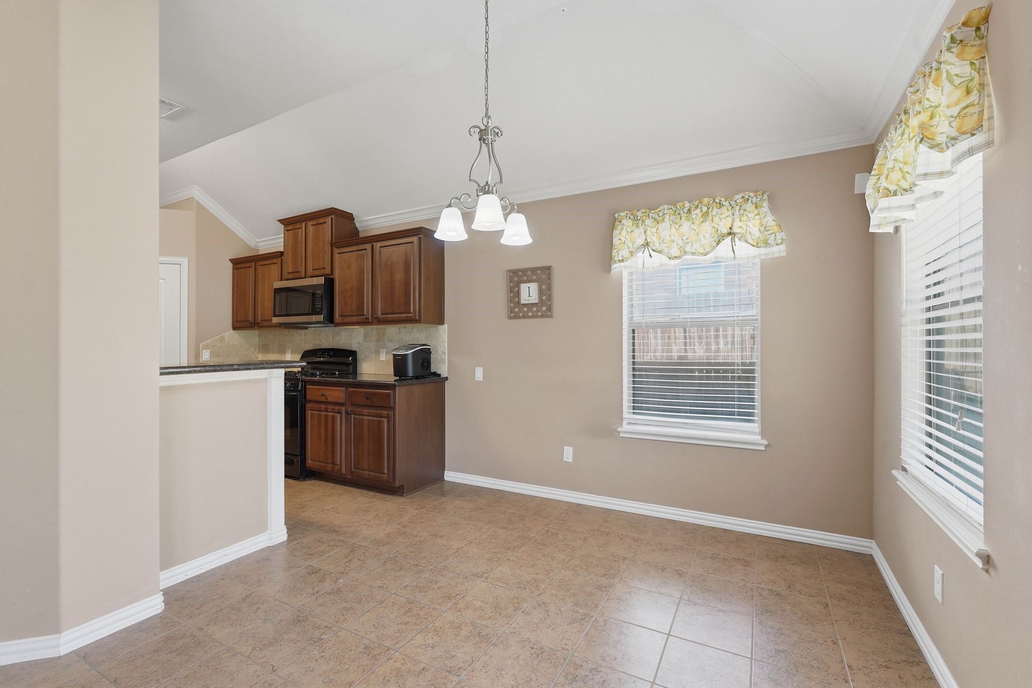 18720 Rosalea Way Montgomery, TX 77356 - Photo 13 of 41 a kitchen with kitchen island granite countertop a stove top oven a sink a counter space and cabinets