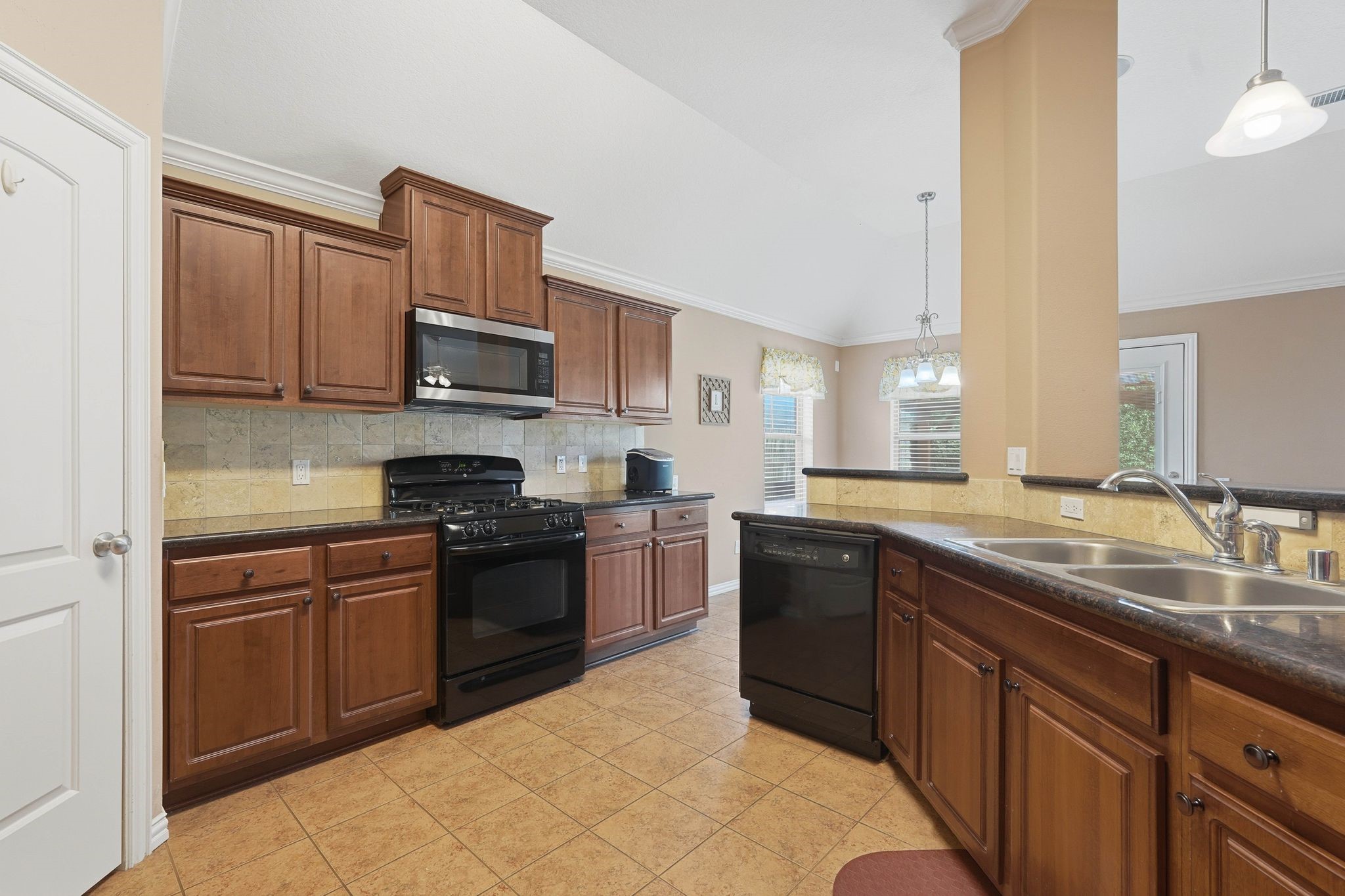 18720 Rosalea Way Montgomery, TX 77356 - Photo 15 of 41 a kitchen with stainless steel appliances granite countertop a sink and stove top oven