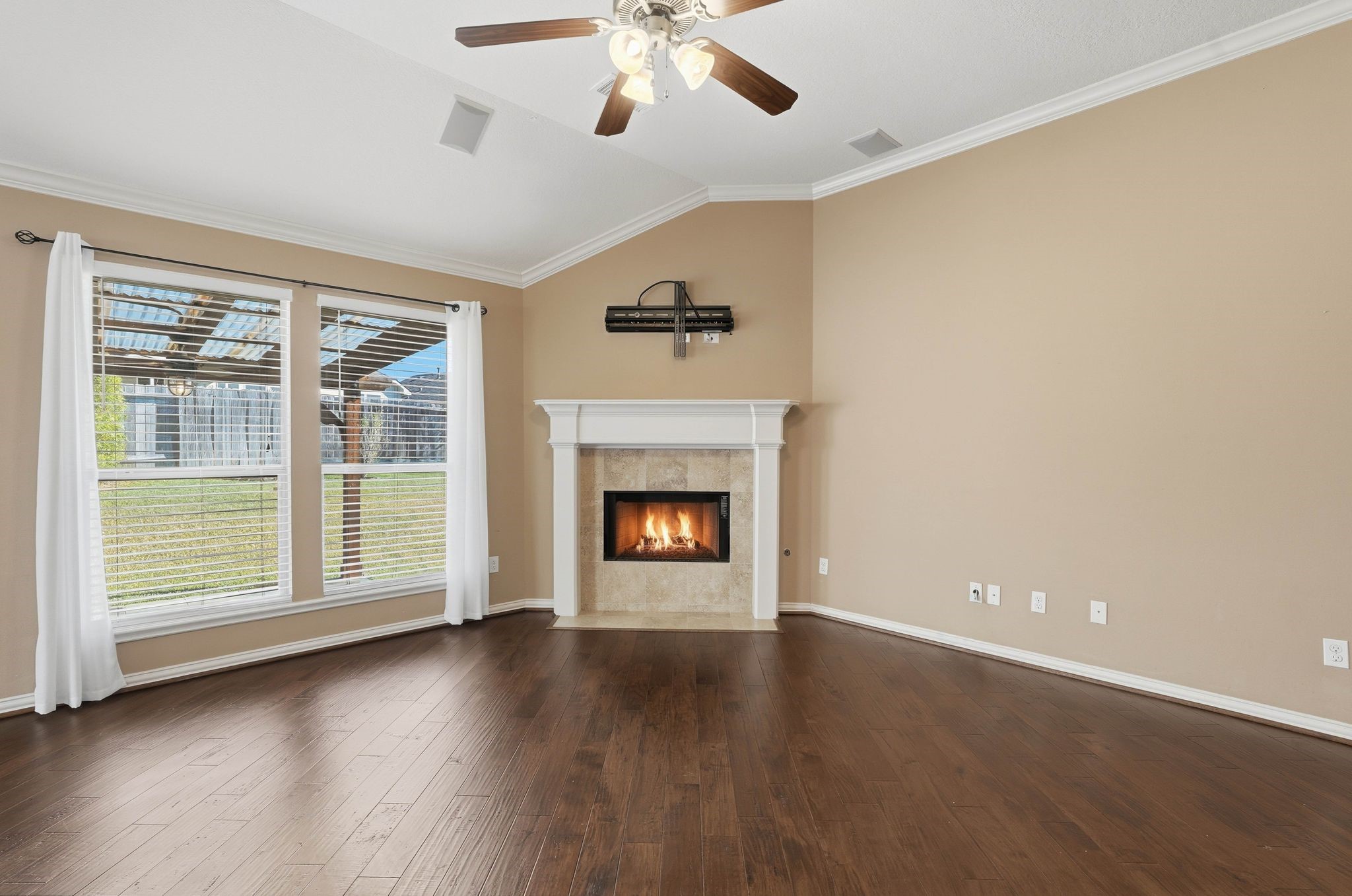 18720 Rosalea Way Montgomery, TX 77356 - Photo 8 of 41 an empty room with wooden floor fireplace and windows