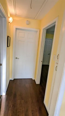 an entryway door with wooden floor