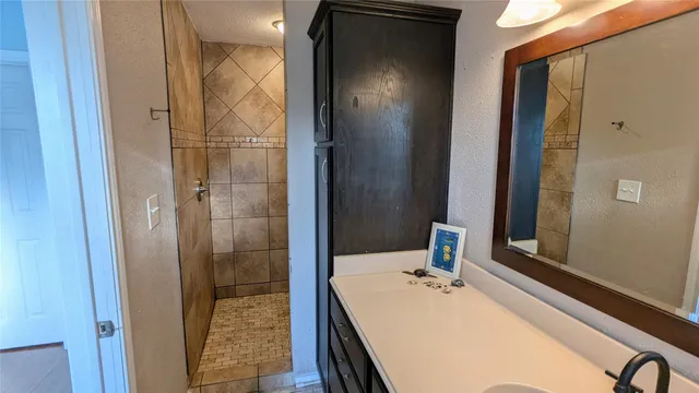 a bathroom with a tub and shower