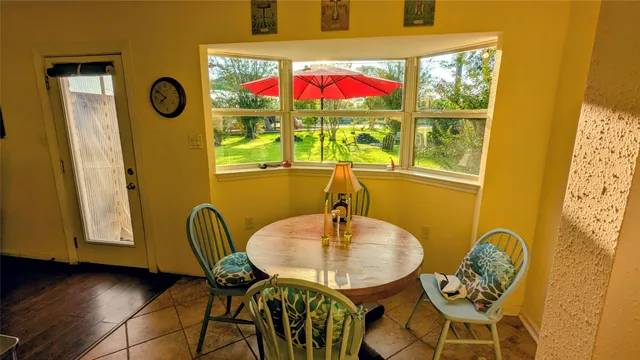 a view of a dining room with furniture and window