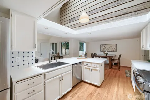 a kitchen with sink stove and cabinets