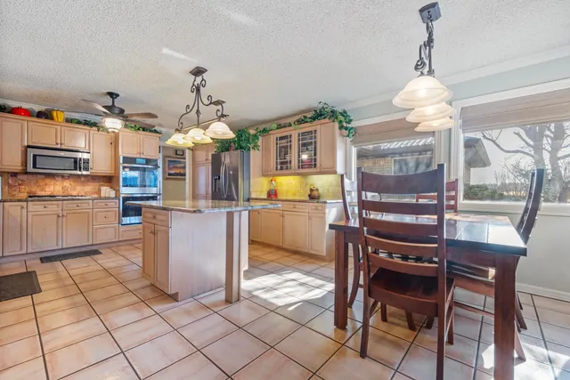 a view of a dining room with furniture wooden floor and a chandelier