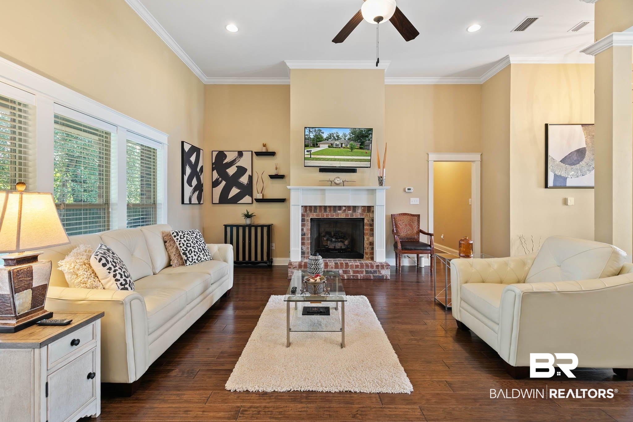 19740 Bunker Loop Fairhope, AL 36532 - Photo 6 of 33 Living area featuring crown molding, dark wood-style flooring, ceiling fan, recessed lighting, and a fireplace
