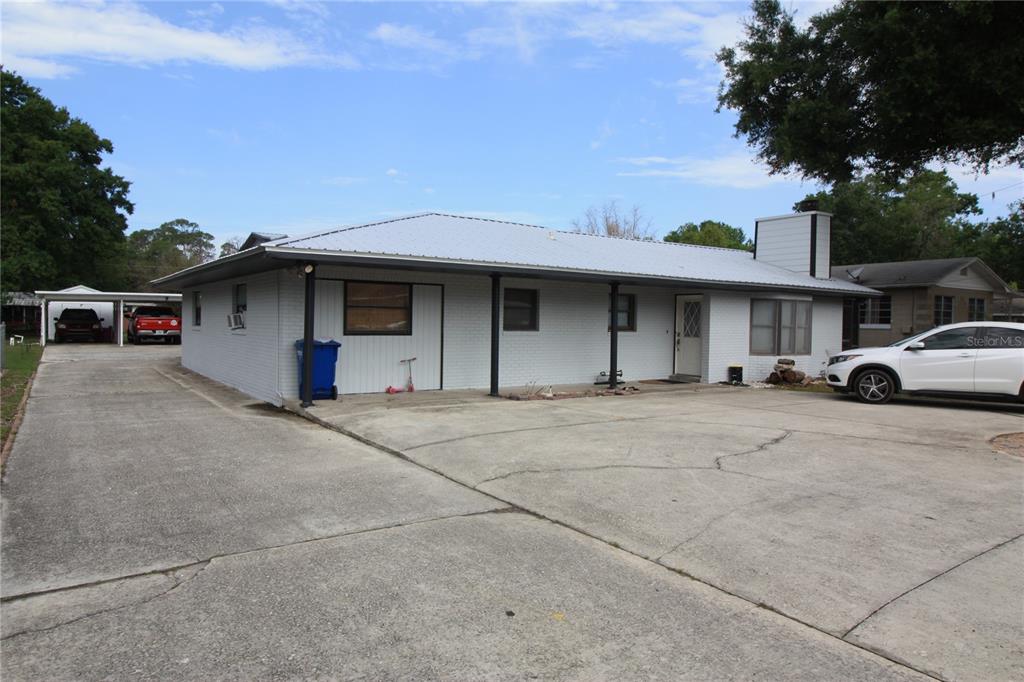 521 20th Street Southwest, Unit C Winter Haven, FL 33880 - Photo 2 of 18 a front view of a house with parking space