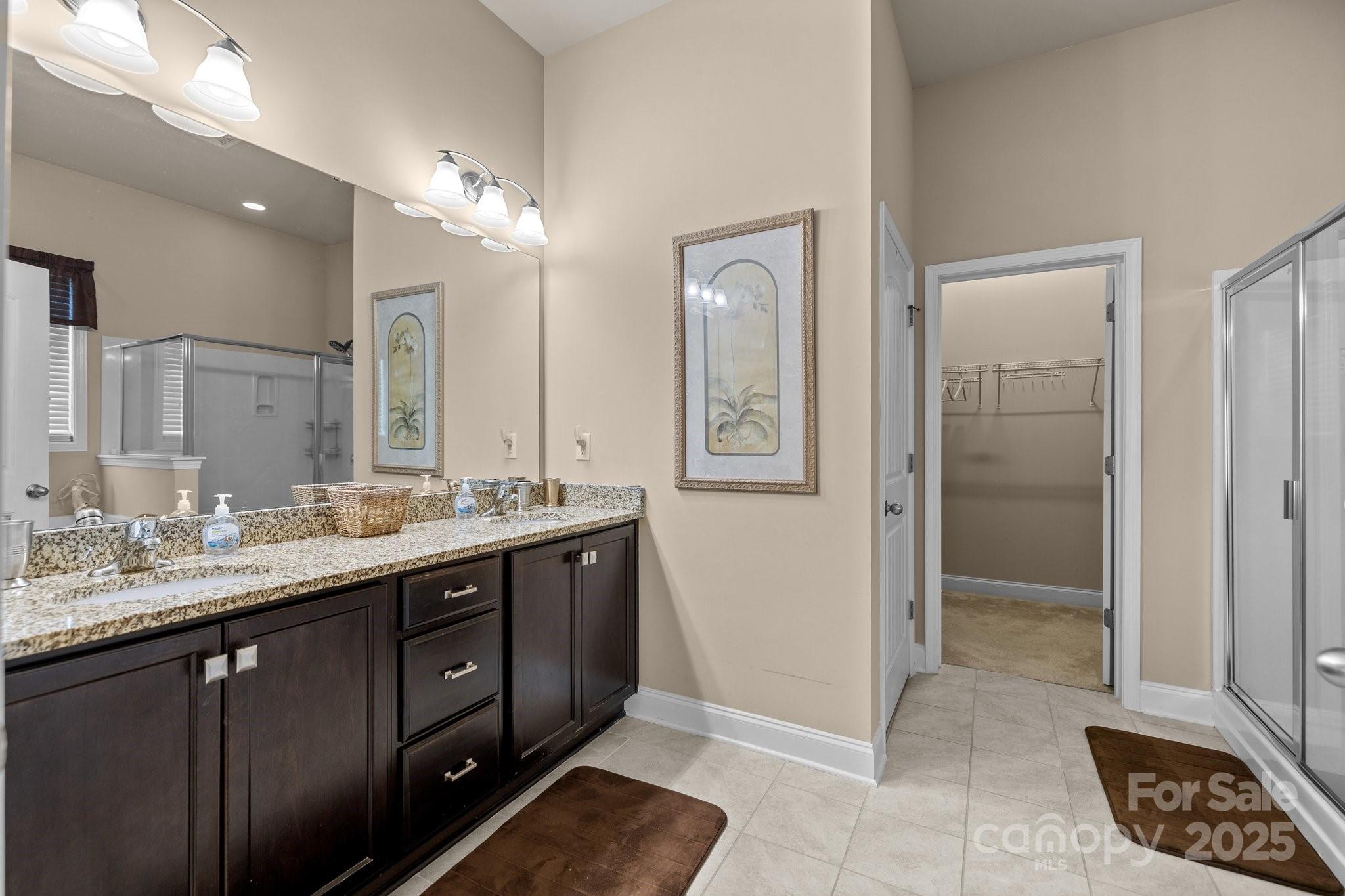 3006 Cricket Lane Lancaster, SC 29720 - Photo 15 of 28 a spacious bathroom with a double vanity sink a mirror and a shower