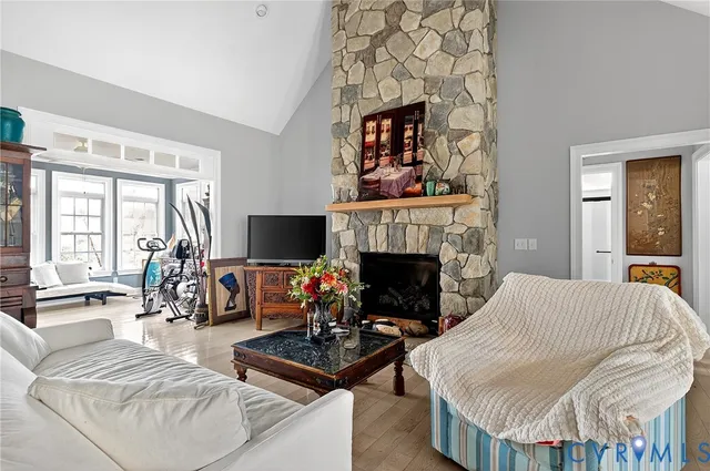 a kitchen with stainless steel appliances granite countertop a sink a stove top oven a refrigerator with wooden cabinets and floor