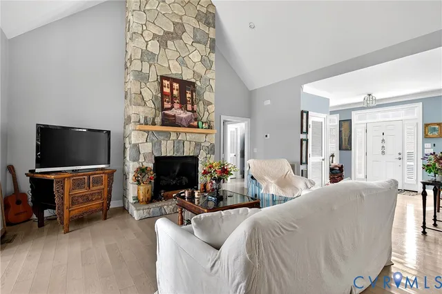 a living room with furniture flowers and a chandelier