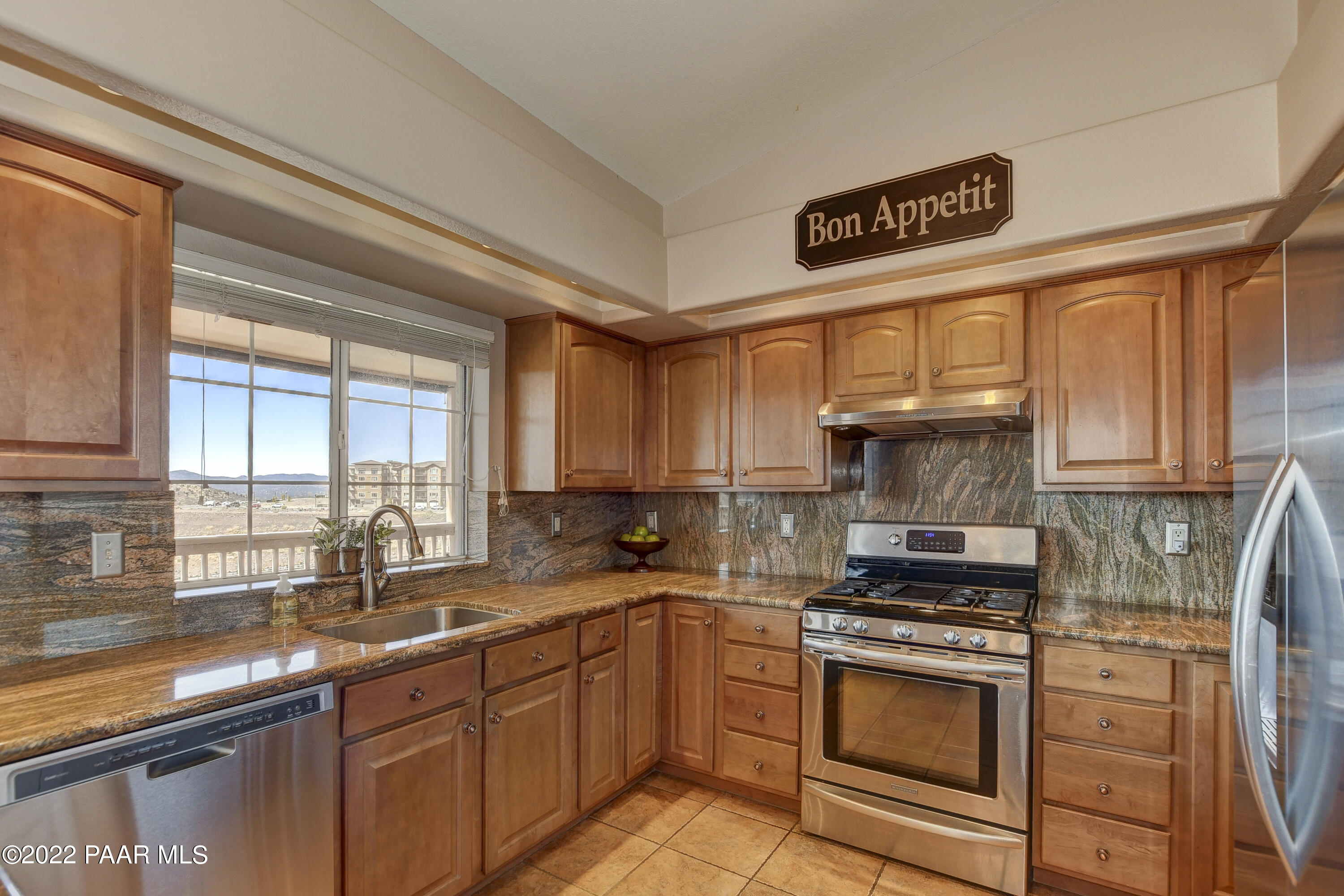 484 Miracle Rider Road Prescott, AZ 86301 - Photo 12 of 32 a kitchen with stainless steel appliances a sink stove and cabinets