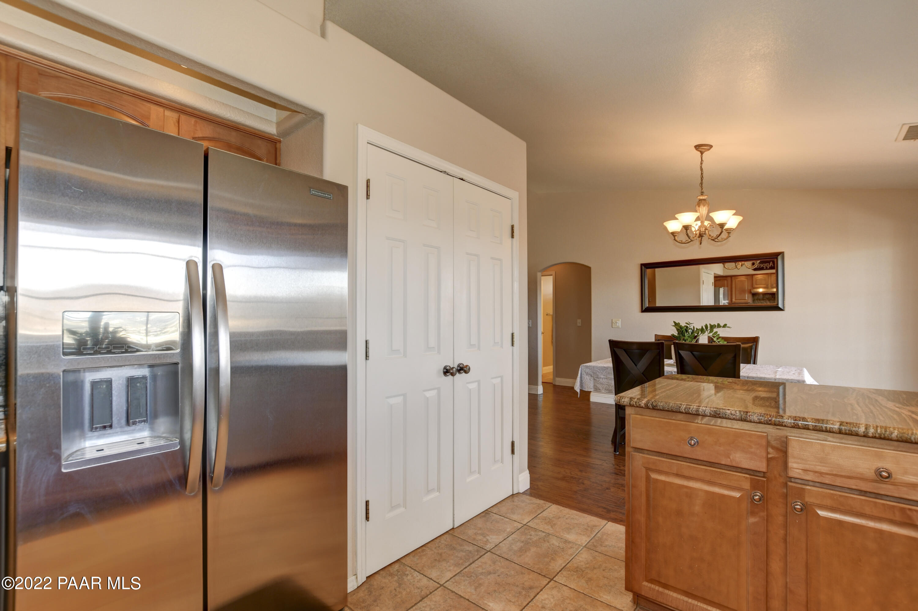 484 Miracle Rider Road Prescott, AZ 86301 - Photo 13 of 32 a kitchen with kitchen island a counter top space appliances and a ceiling fan