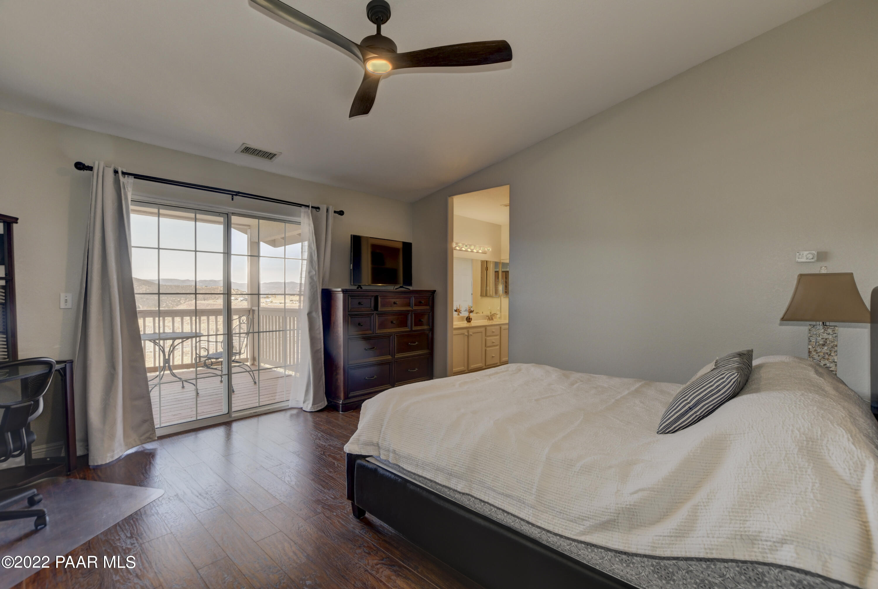 484 Miracle Rider Road Prescott, AZ 86301 - Photo 16 of 32 a bedroom with a bed and wooden floor