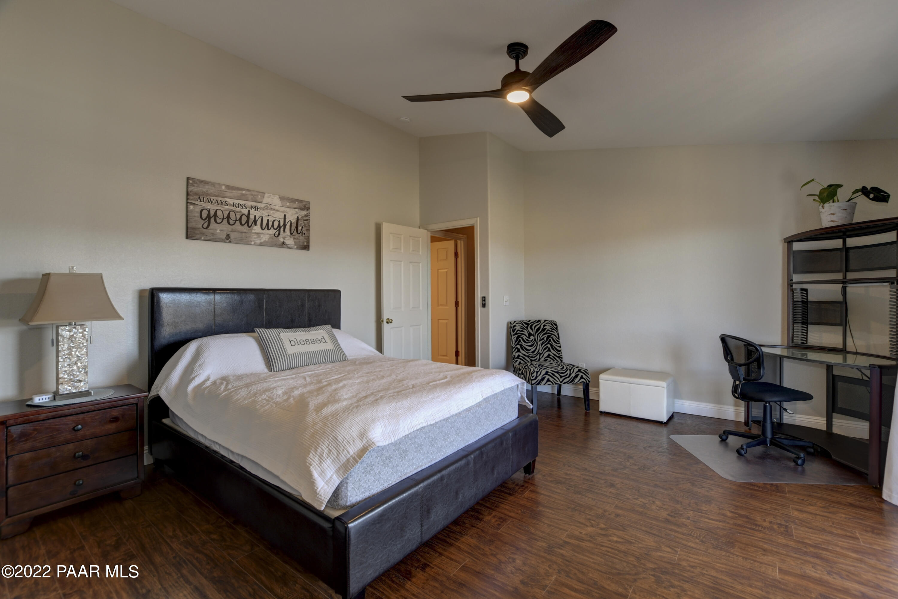484 Miracle Rider Road Prescott, AZ 86301 - Photo 17 of 32 a bedroom with a bed a table and chair