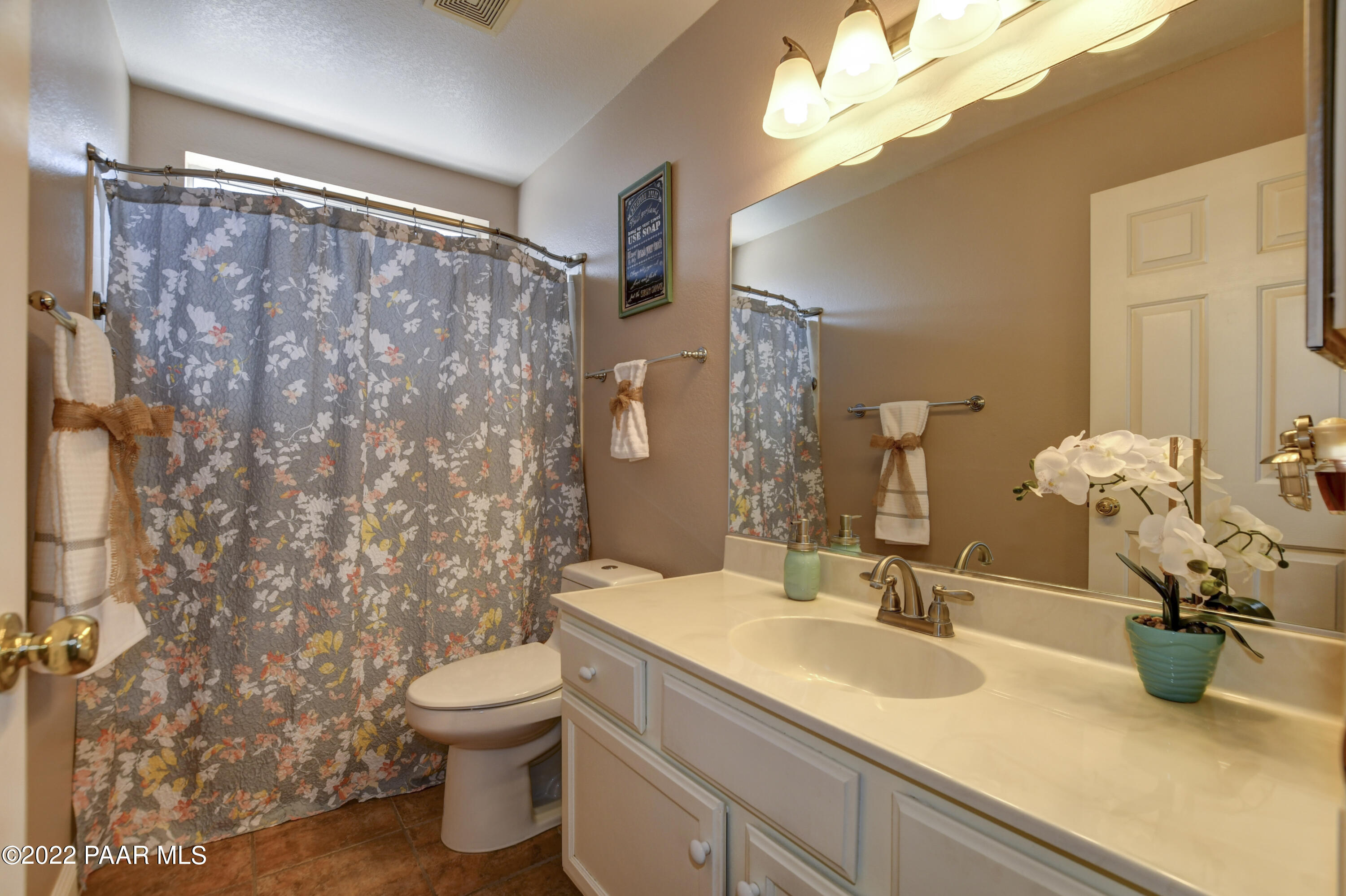 484 Miracle Rider Road Prescott, AZ 86301 - Photo 22 of 32 a bathroom with a granite countertop sink a toilet and a mirror