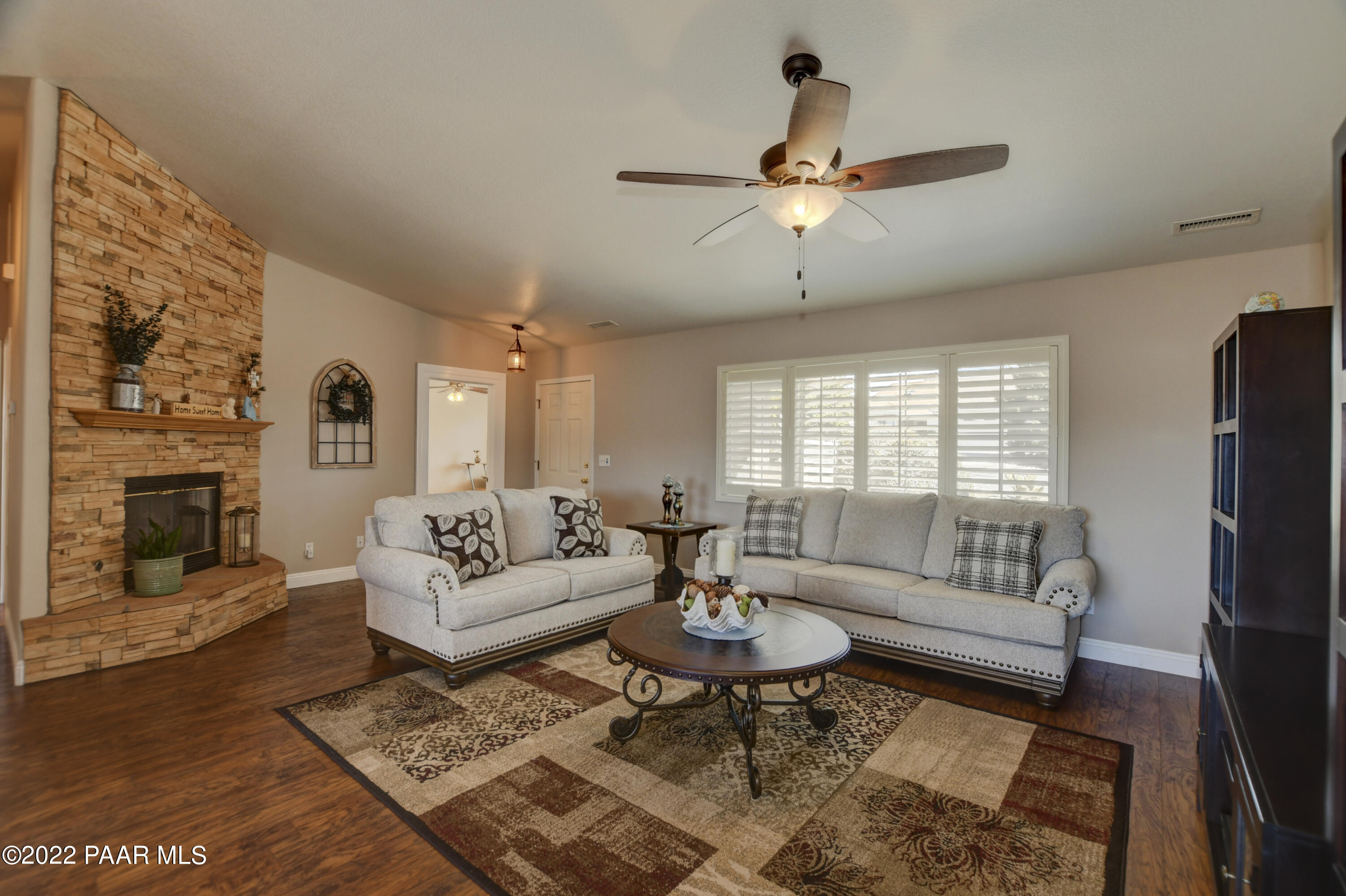 484 Miracle Rider Road Prescott, AZ 86301 - Photo 5 of 32 a living room with furniture a fireplace and a flat screen tv