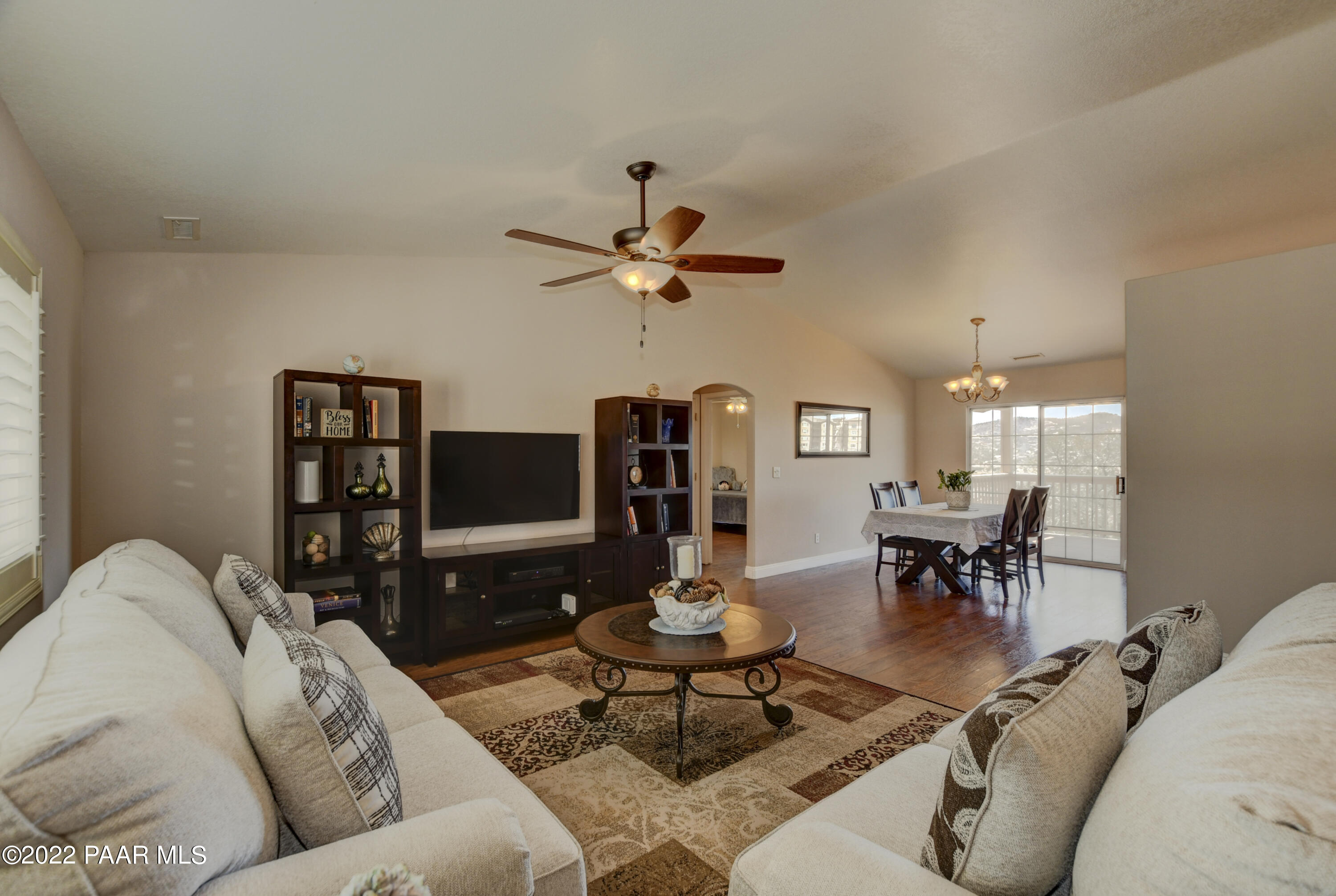 484 Miracle Rider Road Prescott, AZ 86301 - Photo 8 of 32 a living room with furniture a chandelier and a flat screen tv