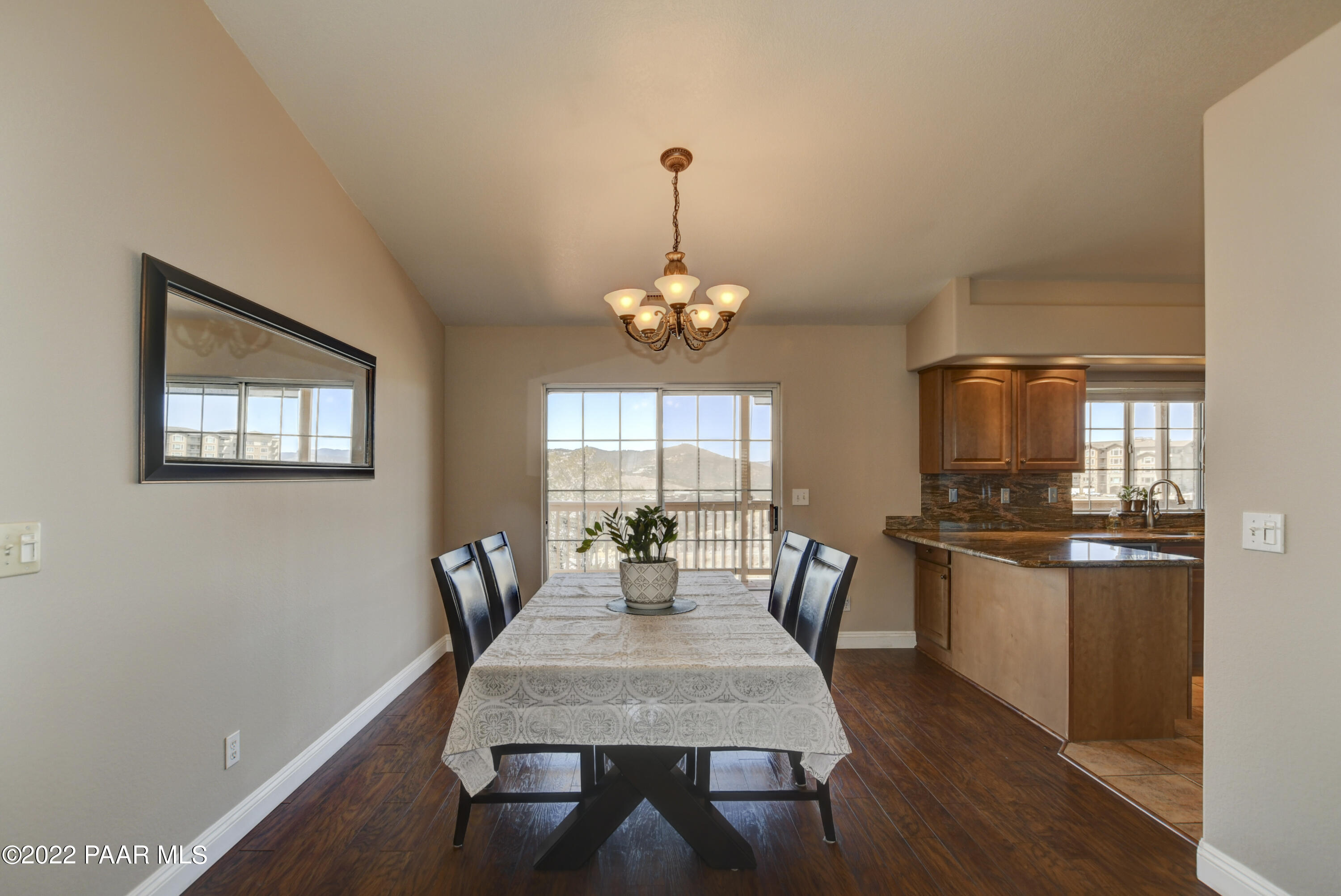 484 Miracle Rider Road Prescott, AZ 86301 - Photo 10 of 32 a dining room with furniture a chandelier and wooden floor