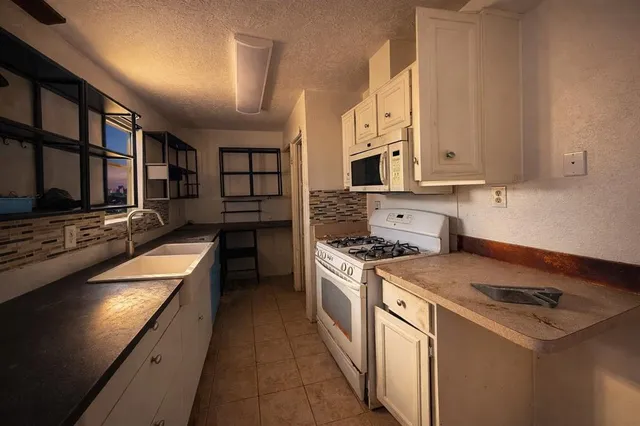 a kitchen with stainless steel appliances granite countertop a stove and a sink