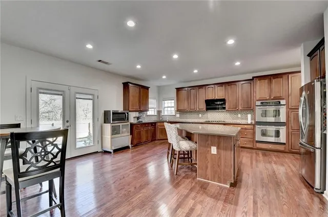 a view of a room with wooden floor and a window