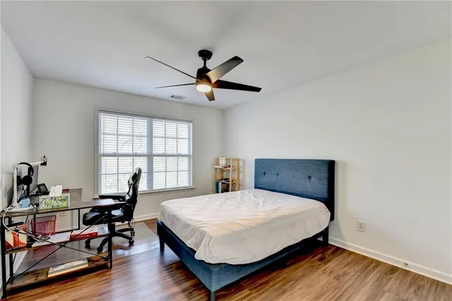 an aerial view of a house with outdoor space and trees all around