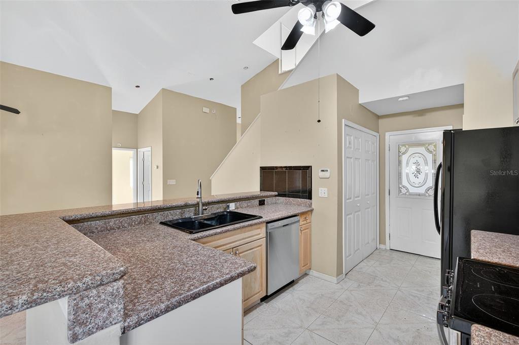 148 Lookout Drive Apollo Beach, FL 33572 - Photo 27 of 71 a kitchen with stainless steel appliances granite countertop a sink and a refrigerator