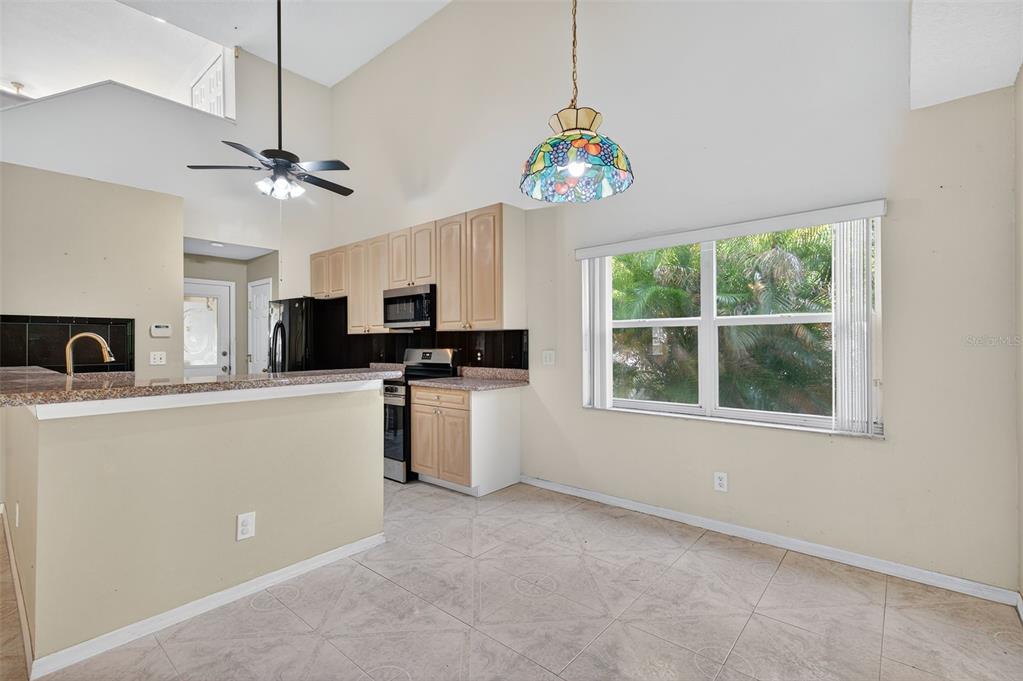 148 Lookout Drive Apollo Beach, FL 33572 - Photo 29 of 71 a kitchen with stainless steel appliances granite countertop a microwave a stove and a window