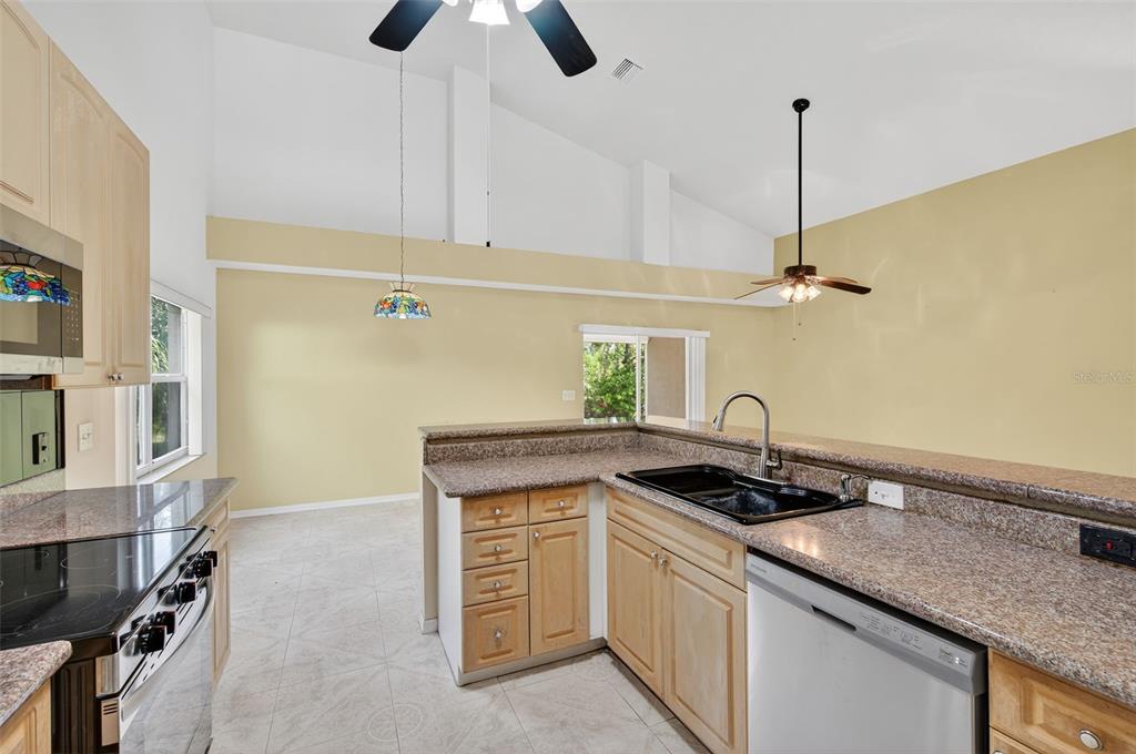 148 Lookout Drive Apollo Beach, FL 33572 - Photo 37 of 71 a kitchen that has a sink a stove and a wooden floor