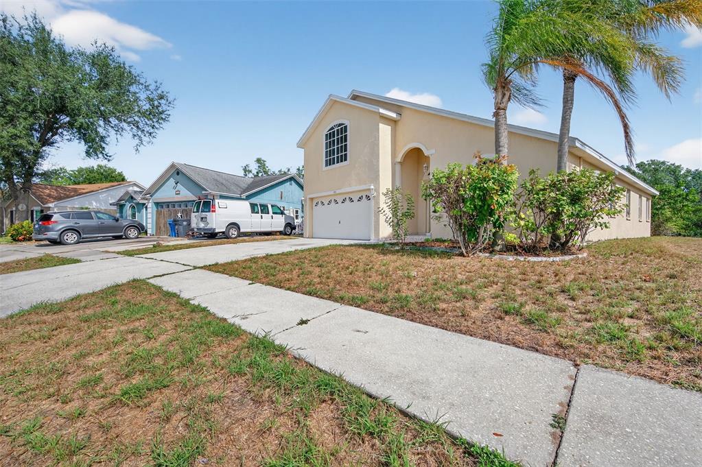 148 Lookout Drive Apollo Beach, FL 33572 - Photo 6 of 71 a front view of a house with a yard and garage