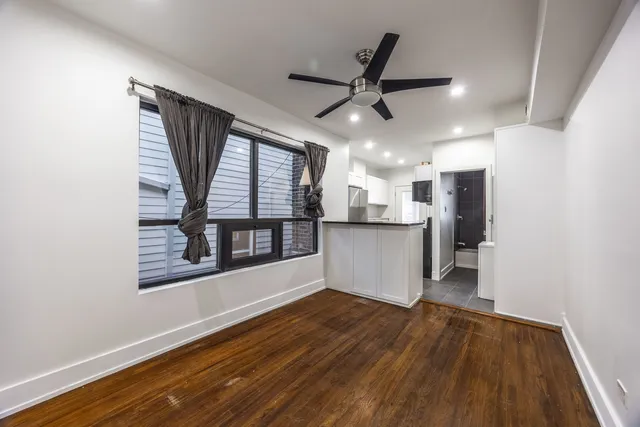 a view of a room with wooden floor and windows