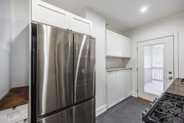 a kitchen with stainless steel appliances granite countertop a refrigerator and a stove