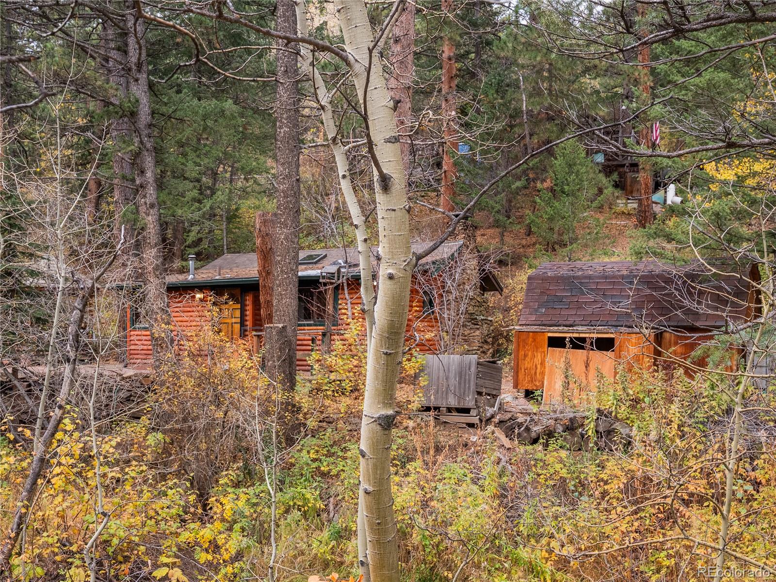 10853 Twin Spruce Road Golden, CO 80403 - Photo 12 of 32 front view of a house with a yard
