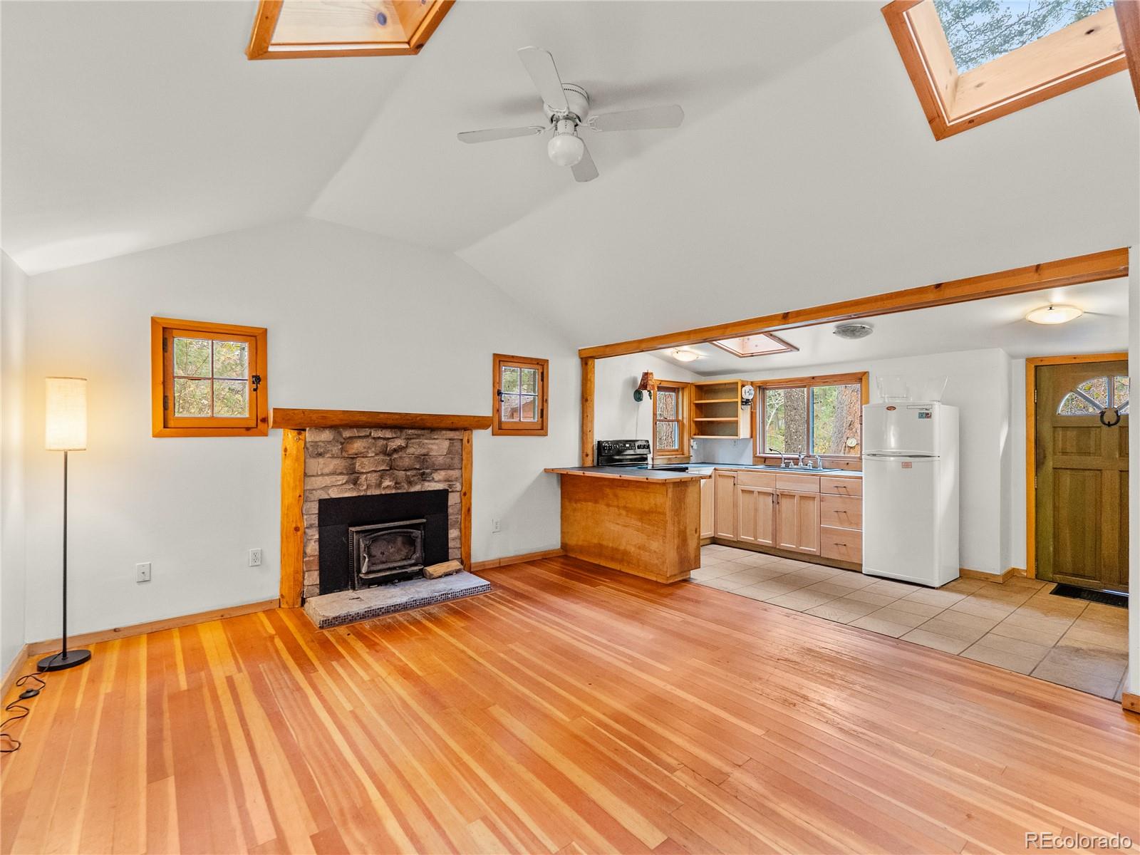 10853 Twin Spruce Road Golden, CO 80403 - Photo 16 of 32 a living room with furniture and a fireplace