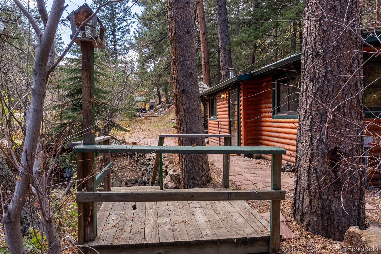 10853 Twin Spruce Road Golden, CO 80403 - Photo 7 of 32 a view of a balcony with wooden fence and floor