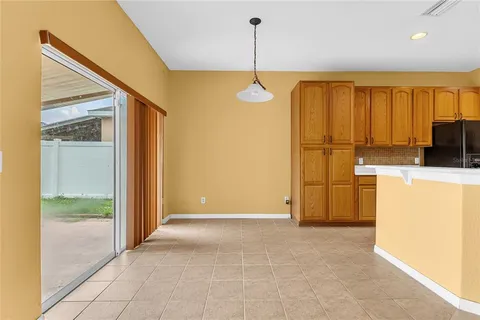 a view of a kitchen with a refrigerator and a sink