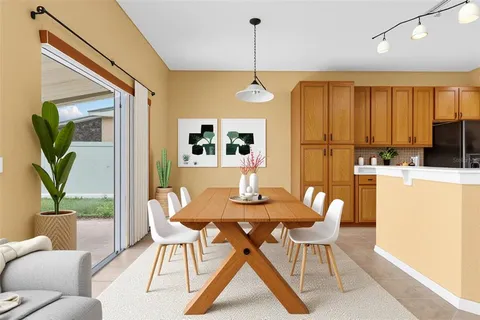 a dining room with furniture and a chandelier