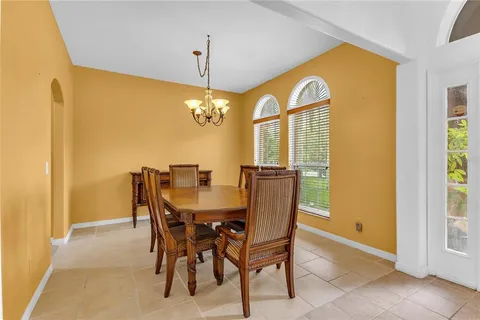 a view of a dining room with furniture and a chandelier