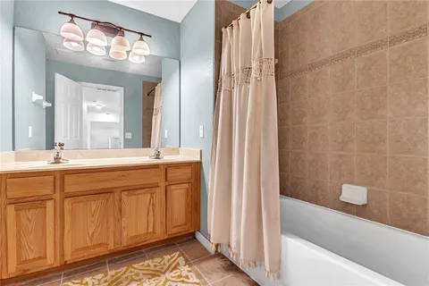 a bathroom with a double vanity sink and a mirror