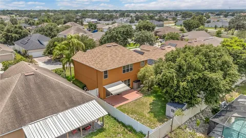an aerial view of a house with a yard
