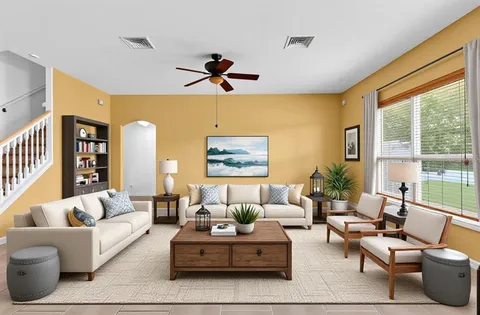 a living room with furniture and a large window