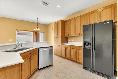 a kitchen with stainless steel appliances granite countertop a refrigerator and a sink