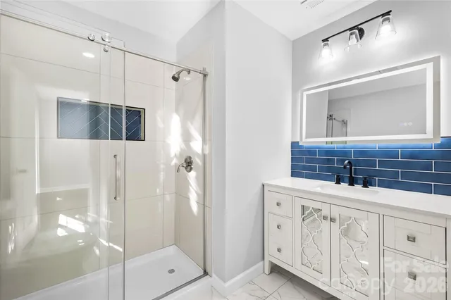 a bathroom with a shower and a sink