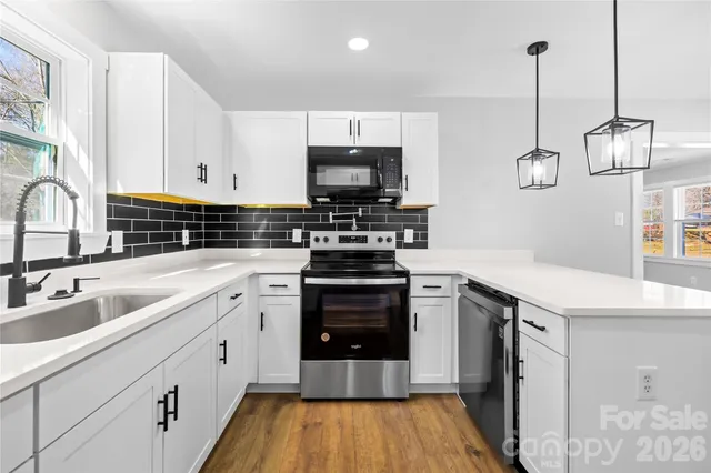 a kitchen with a sink stove and microwave