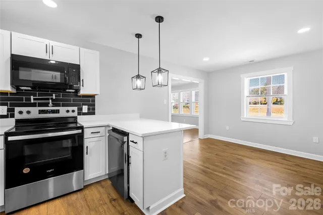 a kitchen with a stove and a microwave
